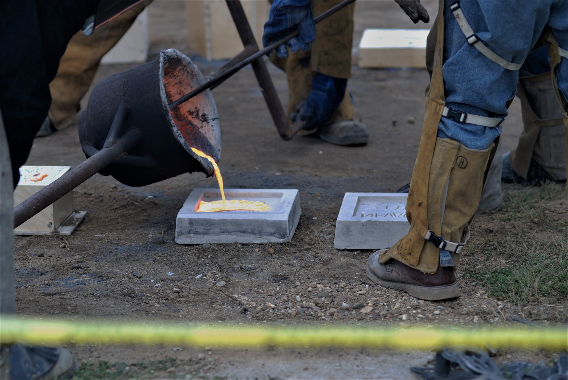 Molten iron being poured from a ladle into a mould